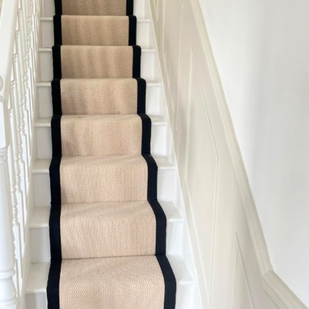 Natural sisal stair runner with black binding fitted to a Victorian staircase